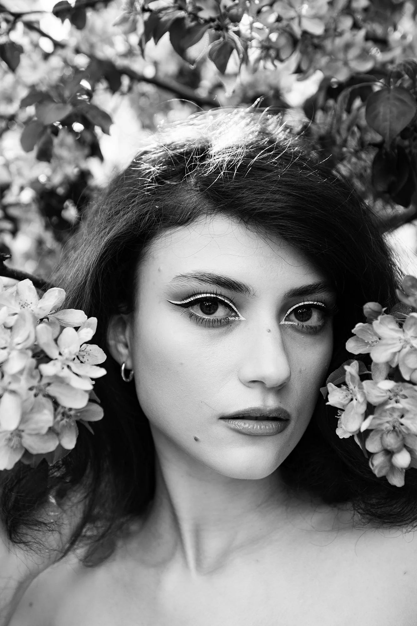 AI Preset Lab Magic AI Kodak T-Max 400 B&W Lightroom Film Preset applied to a fashion portrait of a model surrounded by flowers.